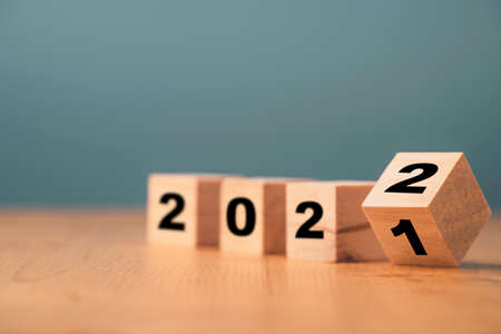 Flipping of wooden cube block for change 2021 to 2022 year , Preparation for merry Christmas and happy new year concept.の写真素材
