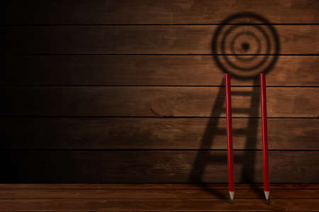 Pencil and stair with target board shadow on wooden background , challenge in business objective...