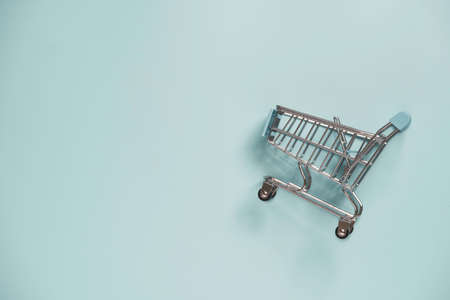 Isolated of Shopping trolley cart on blue background and copy space , Online shopping and e-commerce concept.の写真素材