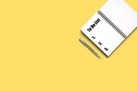 Top view Minimal design of open Notebook with pen and to do list wording on yellow background.