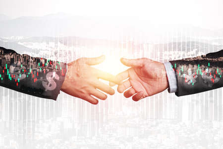 Double exposure Businessman hands shake for business deal and partnership with cityscape and stock...