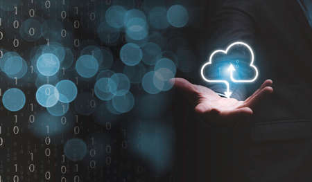 Businessman holding virtual cloud computing on hand to transfer data information and upload download application. Technology transformation concept.の写真素材