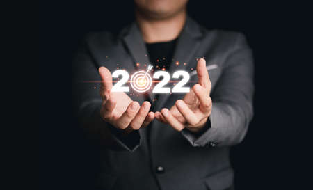 Businessman holding virtual 2022 with target board for setup business objective target for start new year.の写真素材