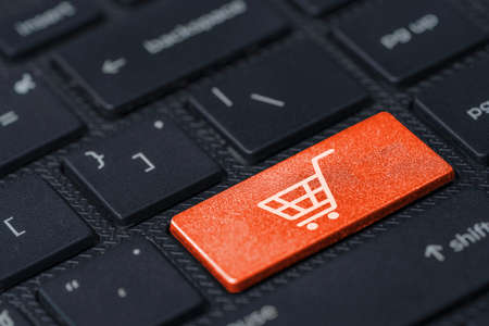 White Trolley or shopping cart icon print screen on Orange button computer keyboard , Shopping online concept.の写真素材