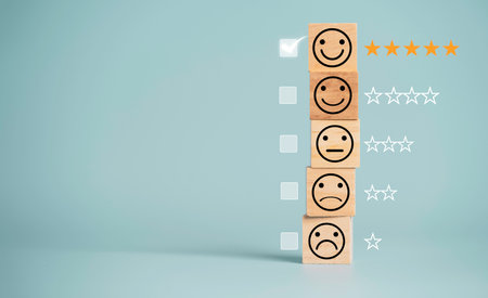 Customer satisfaction survey concept, human face icons print screen on wooden cube block with stars and mark on blue background for evaluate product and service.の写真素材