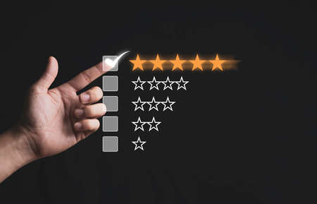 Hand touching and doing mark to five yellow stars on black background, the best customer...