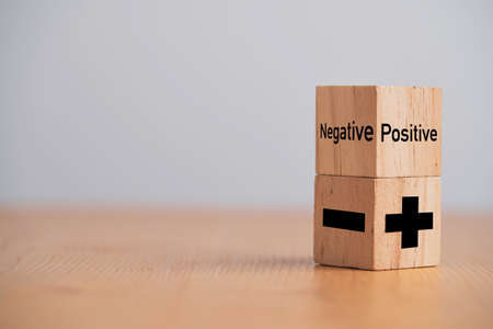 Plus and minus sign on wooden cube block ,Positive and negative thinking and mindset concept.の写真素材