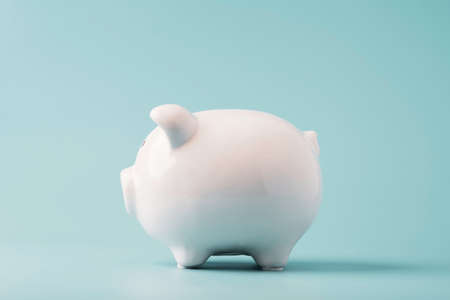 White  piggy bank saving on blue background and copy space ,Money saving for future investment and retirement concept.の写真素材