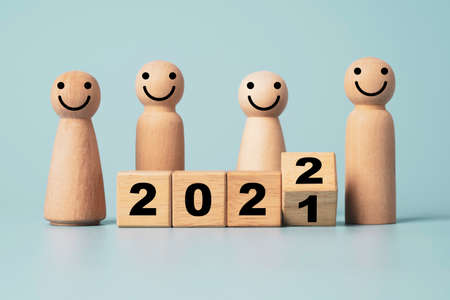 Flipping of wooden cube block for change 2021 to 2022 with wooden figure , Merry Christmas and Happy new year preparation.の写真素材