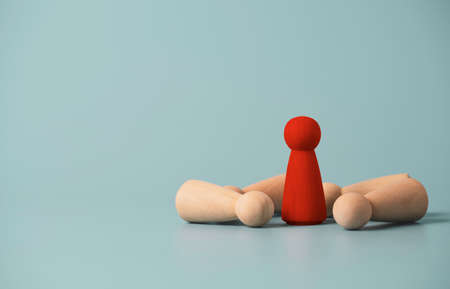 Red wooden figure only one standing with falling figure for business  winner with competition concept.の写真素材