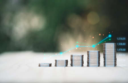 Coins stacking with virtual technical graph for value investment and trader concept.の写真素材