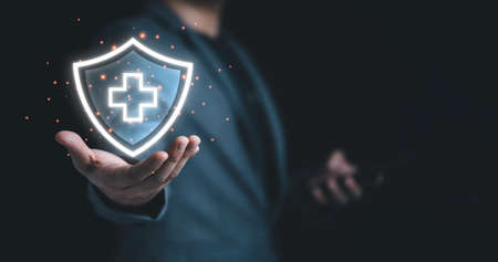 Businessman holding virtual protect health and insurance sign with copy space.の写真素材