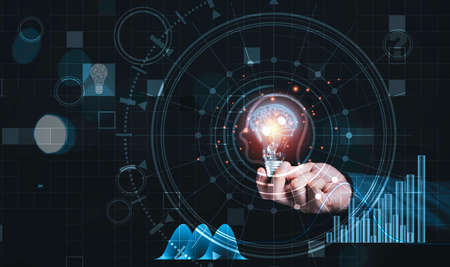 Businessman holding lightbulb with virtual brain and infographic, reative thinking ideas and...
