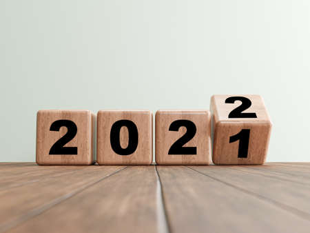 Flipping wooden cube block for change 2021 to 2022 on wooden floor for preparation merry Christmas and happy new year, 3d renderingの写真素材