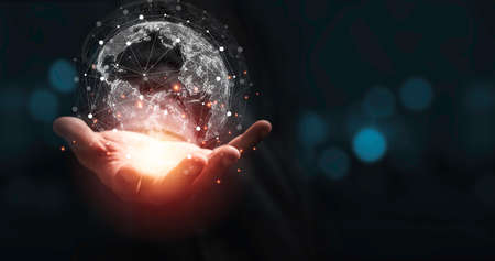 Hand holding virtual world with copy space and blue bokeh background for technology information and...