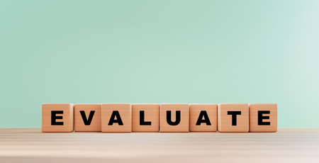 Evaluation wording print screen on wooden cube block on table for client or customer will evaluate...
