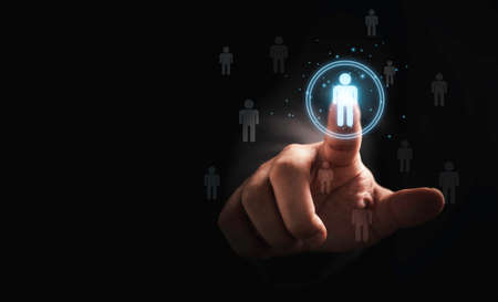 Businessman touching to virtual human icon for focus customer group or human recruitment and development concept.の写真素材