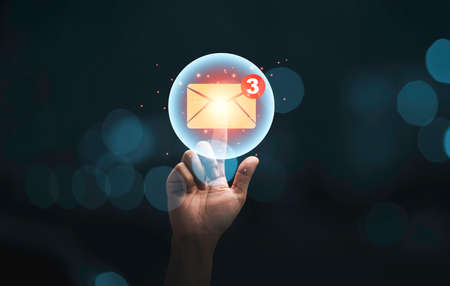 Businessman hand touching to yellow newsletters and notification for business e-mail and business communication concept.の写真素材