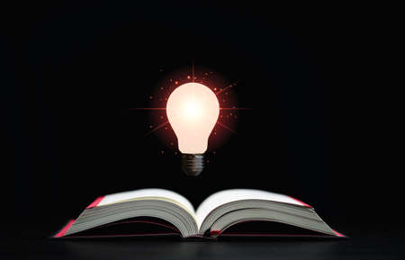 Glowing lamp floats above an open book on dark background which is a symbol of study  a knowledge...