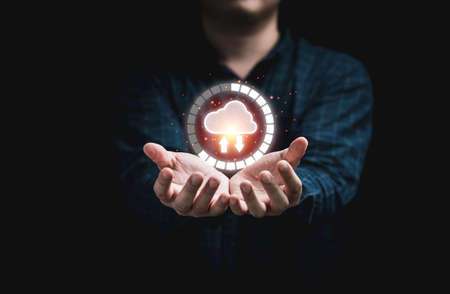 Businessman holding virtual cloud computing with download percentage for transfer data information and upload download application. Technology transformation concept.の写真素材