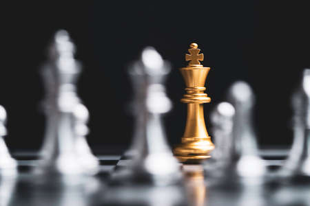 Golden king chess encounter with silver chess enemy on dark background and connection line for strategy idea and futuristic conceptの写真素材