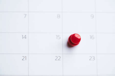 Red pin lace to white calendar with copy space for appointment plan concept.の写真素材