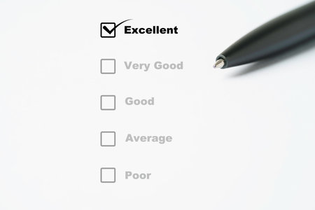 Black pen array on survey sheet which tick mark to excellent result for customer evaluation after use product and service concept.の写真素材