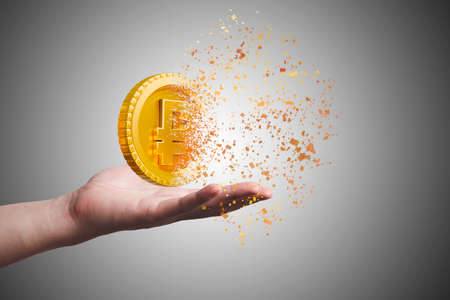 Hand holding Golden Russia Ruble coin which dissolving into a little particles for Ruble depreciate...