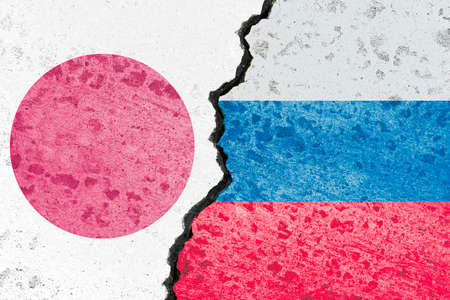 Russia flag and Japan flag print screen on crack wall for business competition and military war conflict between both countries.の写真素材