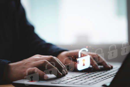 Businessman typing on keyboard laptop computer to input username and password for or technology security system and prevent hacker concept.の写真素材