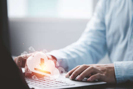 Businessman using laptop computer with virtual cloud computing with copy space to transfer data...