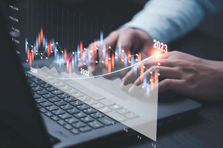 Trader or Fund manager using computer laptop to drawing technical graph and chart for analysis stock...