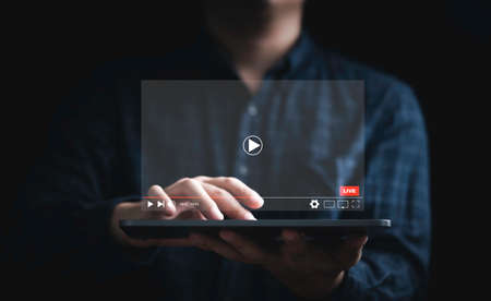 Man holding tablet and watching for live streaming for Video streaming on internet and multimedia technology concept.の写真素材