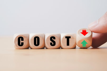 Hand flipping between green up arrow and red down arrow with cost wording for product increase and decrease price which related with demand and supply , inflation and deflation concept.の写真素材