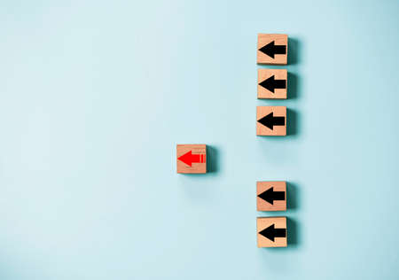 Red arrow move out from black arrows group for leadership and outstanding performance concept.の写真素材