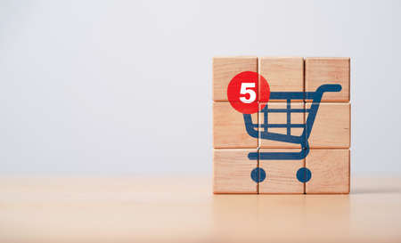 Notification number on shopping trolley cart icon print screen on wooden cube block for alarming of...