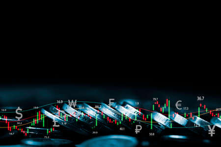 Coins stacking with stock market graph chart  for business investment in stock market analysis ,currency exchange and financial planing concept.の写真素材
