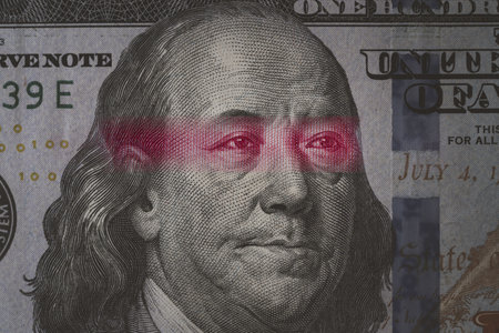 Mao Tse Tung eye from Yuan banknote insert on Benjamin Franklin face on USD dollar banknote for...