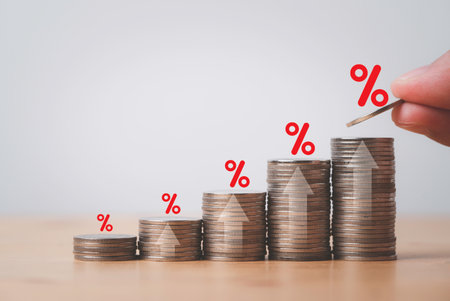 Increasing coin stacking with up arrow and percentage sign for increase financial interest rate and business investment growth from dividend concept.の写真素材