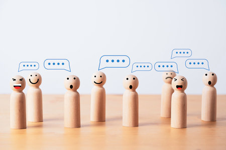 Group of wooden figure with comment message box cloud for customer feedback or group discussion for problem solving concept.の写真素材