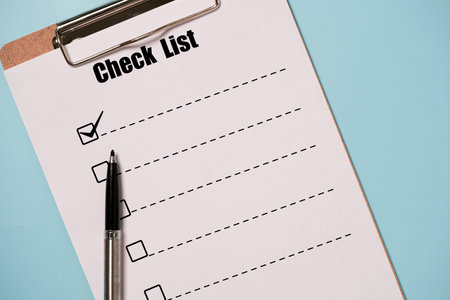 Pen tick mark sign with check list paper sheet and clipboard on blue background for to do list or planing concept.の写真素材