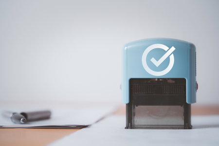 Closeup of stamping for approve document on table for business permit and ISO certificate concept.