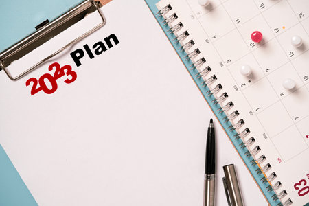 2023 year on business planning notebook with calendar and pin for  make strategic action plan item...