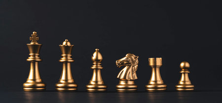Golden chess include king queen horse ship and pawn on dark background.の写真素材