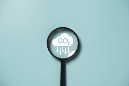 CO2 reducing icon inside magnifier glass for focusing decrease CO2 or carbon dioxide emission ,carbon footprint and carbon credit to limit global warming from climate change concept.の写真素材