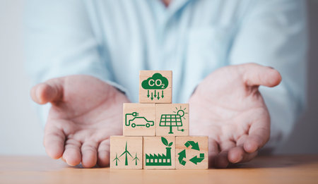 Businessman giving CO2 reducing ,Recycle ,Green factory icon for decrease CO2 , carbon footprint and carbon credit to limit global warming from climate change, Bio Circular Green Economy concept.の写真素材