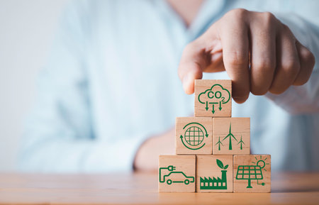 Businessman stacking CO2 reducing ,Recycle ,Green factory icon for decrease CO2 , carbon footprint and carbon credit to limit global warming from climate change, Bio Circular Green Economy concept.の写真素材