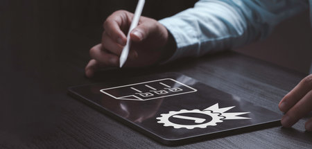 Businessman using tablet with quality assurance and document icon for ISO or International Standard Organisation which related quality control and continuous improvement concept.の写真素材