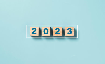 Businessman array wooden cube block with virtual loading bar for count down from 2022 to 2023 year of preparation merry Christmas and happy new year by technology download concept.の写真素材