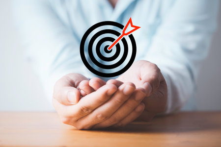 Businessman holding and giving dartboard with arrow for setup business objective target and goal concept.の写真素材
